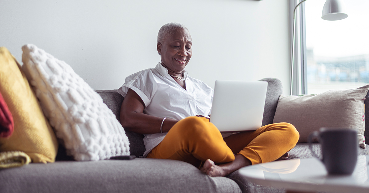 older woman on laptop smilling