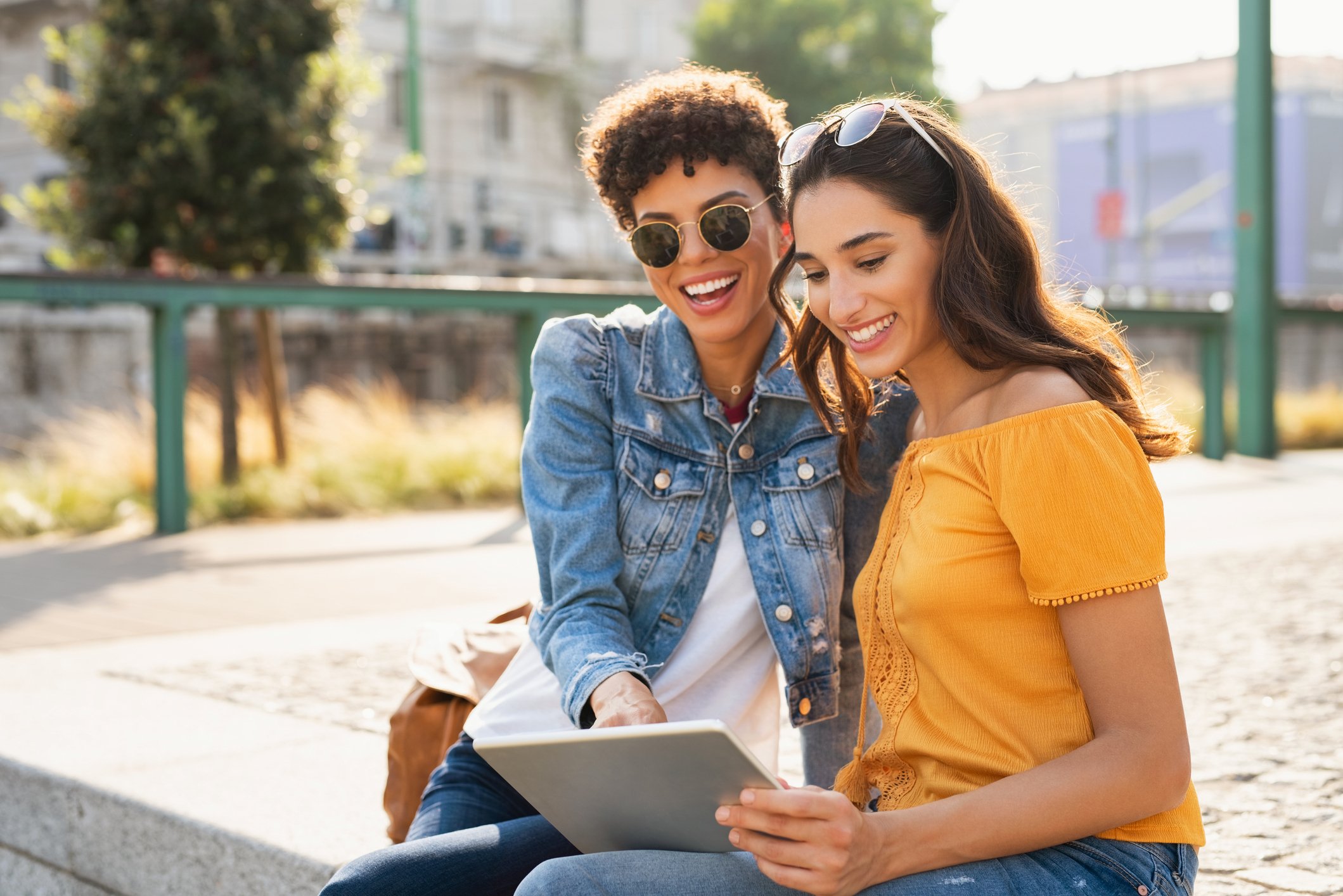 Two people looking at their laptop and smiling