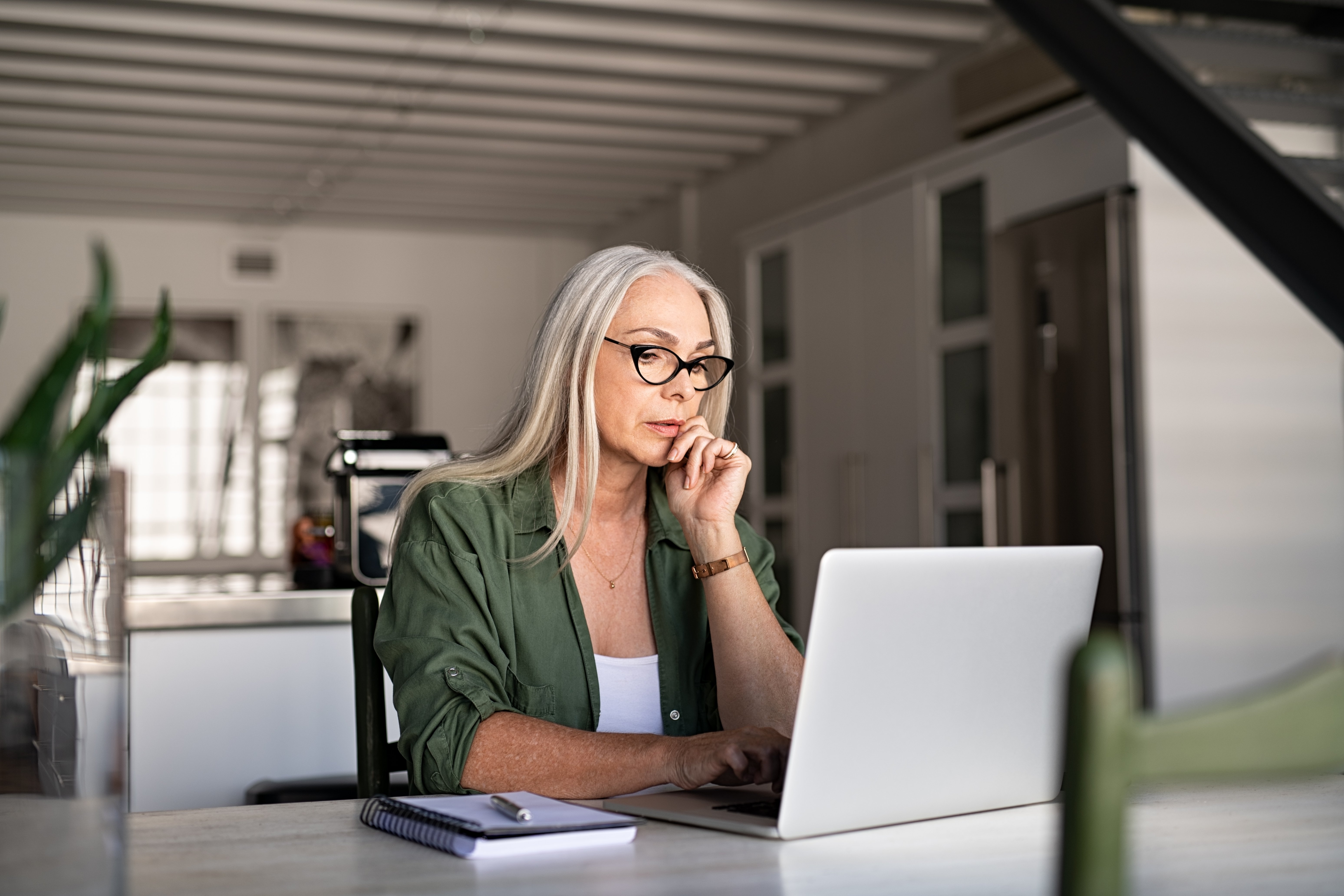 A woman looks at her computer