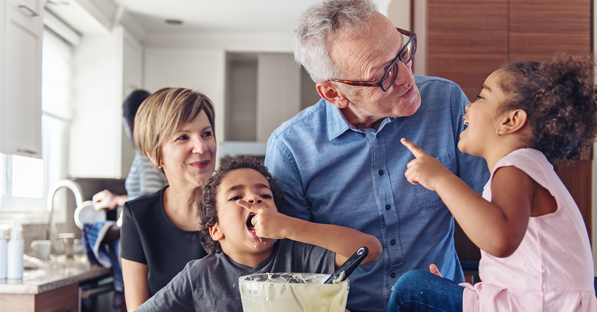 three generation family making pancakes together