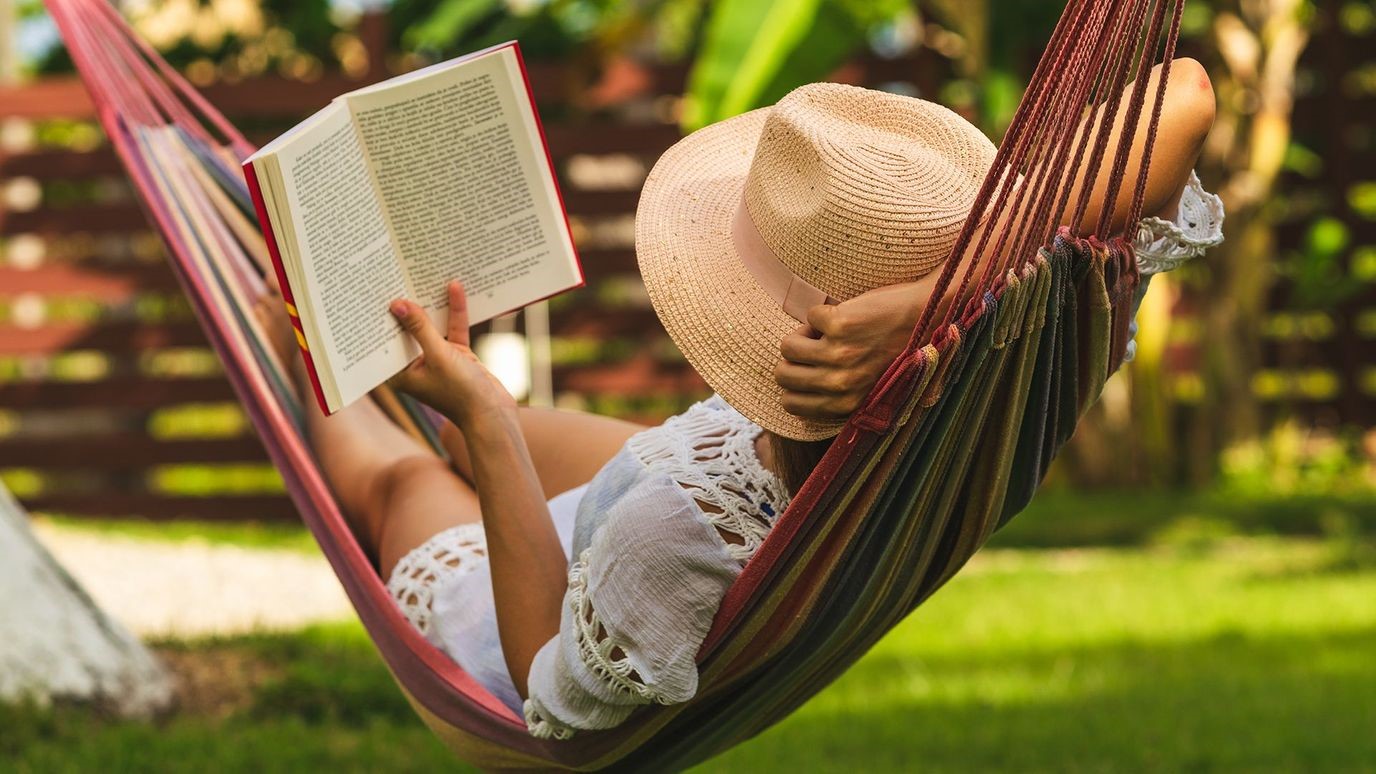 lady relaxing in hammock reading a book