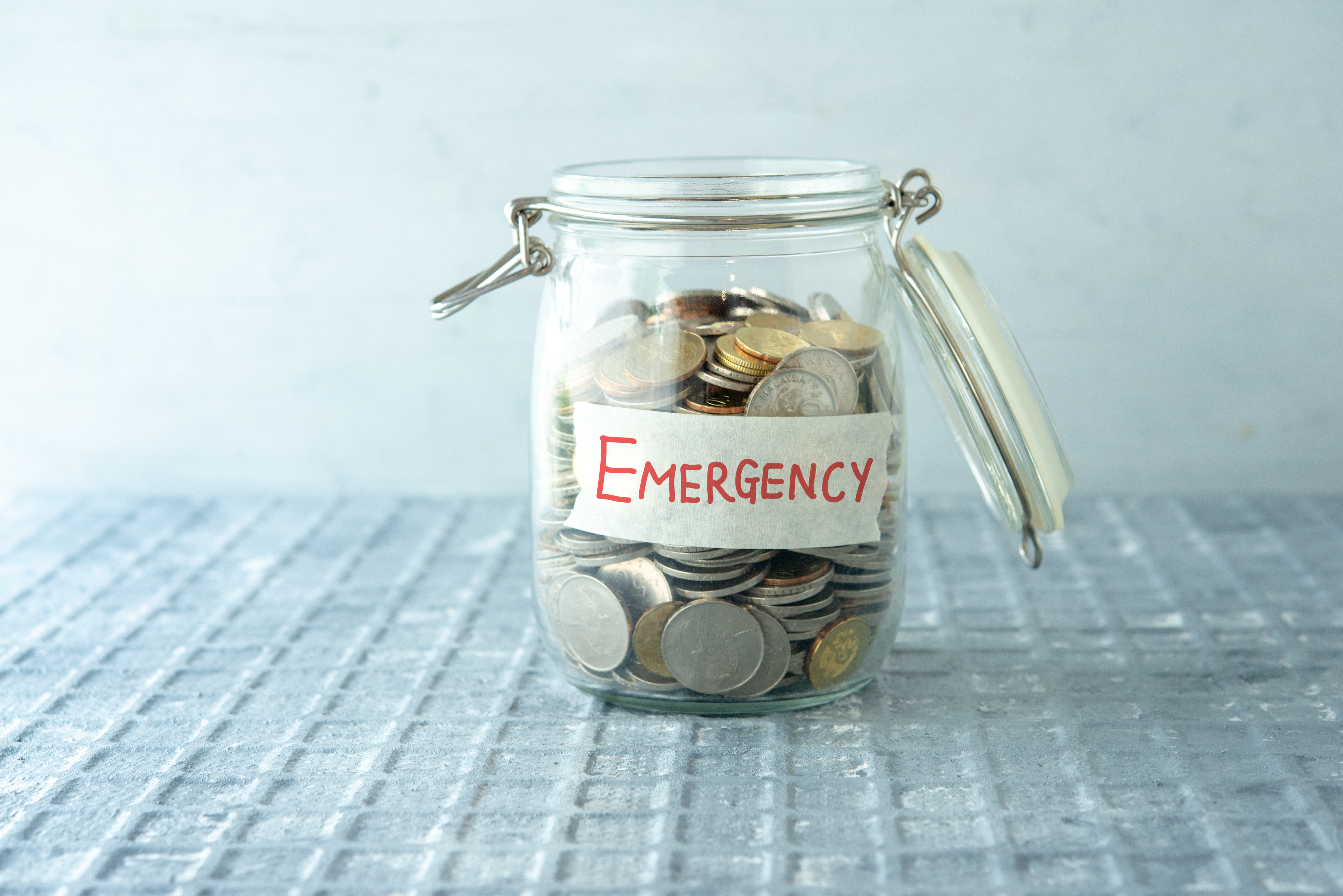 jar of coins with emergency label