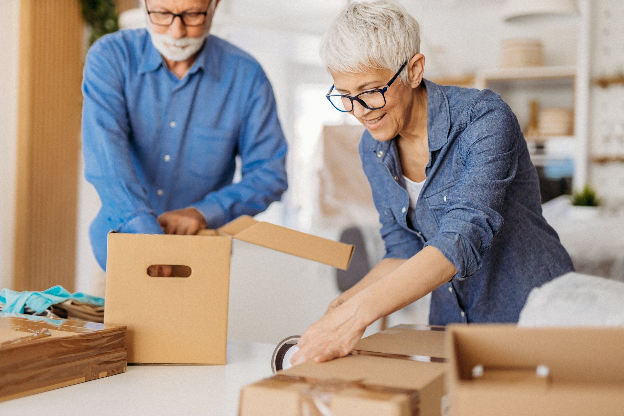 Older couple packing a box